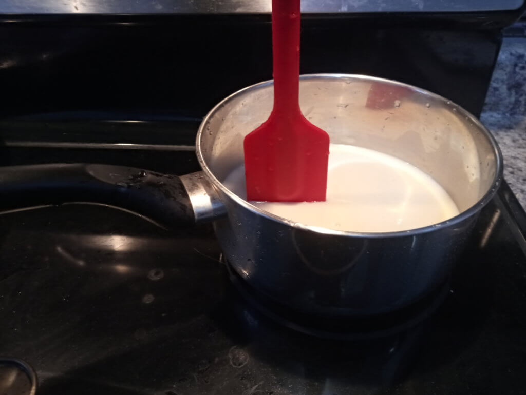 spatula in saucepan of non-dairy milk